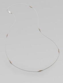 A graceful sterling silver chain, delicately spaced with clusters of tiny, faceted 14k gold beads.14k yellow gold and sterling silverLength, about 26Spring ring claspMade in USA