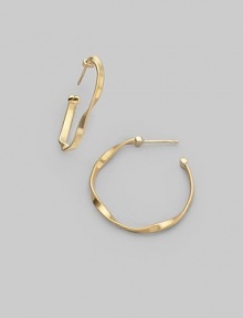 An updated version of a classic hoop, styled in 18k yellow gold with delicate ridges and intriguing twists. 18k yellow gold Diameter, about 1 Post back Made in Italy