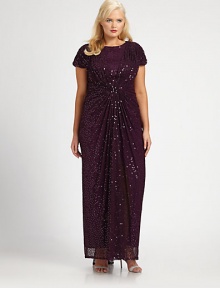 Sequins adorn this gown for an instantly glamorous look. The gathered and ruched details ensure a flattering silhouette.Round neckShort sleevesGathered and ruched detailsFully linedAbout 53 from natural waistNylonDry cleanImported