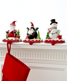 Santa's got it! Topped with a clay figurine of Father Christmas, this too-cute stocking holder keeps gifts hanging, balancing the weight on its sturdy cast iron base.