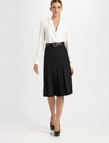 Classic style with topstitched, inverted pleats all around and an unexpected side slit.Waistband Side zipper Side slit About 28½ long 85% wool/15% nylon Dry clean Made in France Classic style with topstitched, inverted pleats all around and an unexpected side slit.Waistband Side zipper Side slit About 28½ long 85% wool/15% nylon Dry clean Made in France