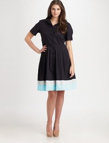 A classic stretch cotton style with a flared skirt featuring a colorblocked hem.Collar styleButton frontCuffed short sleevesAbout 51 from shoulder to hem97% cotton/3% spandexDry cleanMade in USA of imported fabric