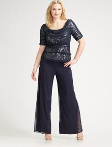 Semi sheer design drapes ever so softly over a sparkly base of sequins. Round neckline Elbow sleeves Concealed back zip Full lining Polyester; dry clean Imported