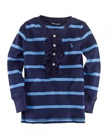 A classic striped crewneck tee is highlighted with a sweet ruffle trim for a feminine update. A classic striped crewneck tee is highlighted with a sweet ruffle trim for a feminine update.