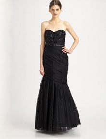 This floor-length tulle silhouette features a sexy corset bodice and delicate beaded details.Strapless sweetheart necklineBeaded, boned corset bodiceBeaded waistbandDraped trumpet skirtConcealed side zipTaffeta liningAbout 63 from shoulder to hemPolyesterDry cleanImportedModel shown is 5'10 (177cm)wearing US size 4. This floor-length tulle silhouette features a sexy corset bodice and delicate beaded details.Strapless sweetheart necklineBeaded, boned corset bodiceBeaded waistbandDraped trumpet skirtConcealed side zipTaffeta liningAbout 63 from shoulder to hemPolyesterDry cleanImportedModel shown is 5'10 (177cm)wearing US size 4.