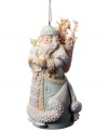 Santa Clause carries a snow globe and basket of gifts in this Nature Santa ornament, featuring detailed leaf and crystal embellishments upon his traditional robe.