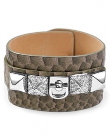 Get spotted in Juicy Couture with this cuff bracelet, crafted of leather and dressed up with bold plated metal studs and a smattering of faux python scales.