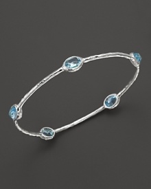 Blue topaz stations sparkle on this textured sterling silver bangle from Ippolita. Blue topaz stations sparkle on this textured sterling silver bangle from Ippolita.