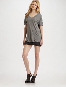 Comfy, silk-blend style with dropped shoulders and a rounded v-neck. Rounded v-neck Short sleeves Dropped shoulders Longer length hits below the hips 67% rayon/33% silk Hand wash Imported