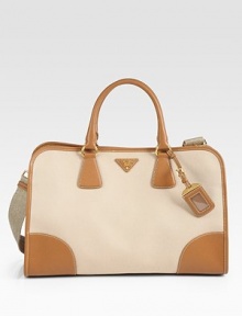 Saffiano leather pairs with canvas in a roomy top-handle design.Double top handles, 5¼ dropDetachable adjustable shoulder strap, 10-19½ dropTop snap closureMetal logo detailLuggage tagProtective metal feetTwo inside zip pocketsThree inside open pocketsFully lined15¾W X 10¼H X 6DMade in Italy Saffiano leather pairs with canvas in a roomy top-handle design.Double top handles, 5¼ dropDetachable adjustable shoulder strap, 10-19½ dropTop snap closureMetal logo detailLuggage tagProtective metal feetTwo inside zip pocketsThree inside open pocketsFully lined15¾W X 10¼H X 6DMade in Italy