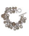 Icy-cool sheen. A silver tone mixed metal setting complements the gray glass beading on Carolee's chic cluster charm bracelet. Glittering charms round out the look and add a touch of glamour. Approximate length: 8 inches.