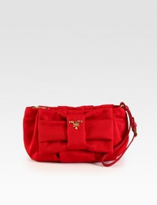 Tessuto nylon design with logo detail and bow.Adjustable wristlet strap, 5½-6 dropTop zip closureSignature jacquard lining8W X 6¼H X 1DMade in Italy Tessuto nylon design with logo detail and bow.Adjustable wristlet strap, 5½-6 dropTop zip closureSignature jacquard lining8W X 6¼H X 1DMade in Italy