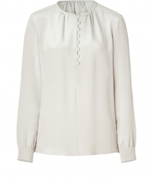 Create an elegant and polished look at the office and beyond with this silk blouse in grey-beige - Small, rounded neckline, button half-placket and subtle decorative ruffles at collar - Long sleeves feature buttoned cuffs - Loose, straight silhouette - Dress up skinny jeans or wear with a pencil skirt or under a suit