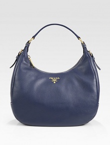 A classic, round shape in textured pebble-grain calfskin leather with a front goldtone logo. Single shoulder strap, 8 dropZipper closureMetal lettering logoBrass hardwareInside zipper pocketOne inside cellphone/credit card pocketPrada logo lining14W x 10H x 5½DMade in Italy A classic, round shape in textured pebble-grain calfskin leather with a front goldtone logo. Single shoulder strap, 8 dropZipper closureMetal lettering logoBrass hardwareInside zipper pocketOne inside cellphone/credit card pocketPrada logo lining14W x 10H x 5½DMade in Italy