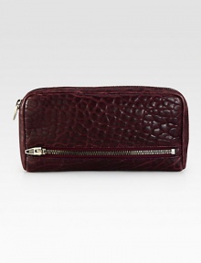 Beautifully pebbled leather with edgy zipper details.Zip-around closureTwo outside zip pocketThree bill compartmentsTwelve credit card slotsFully lined8¼W X 4½H X 1DImported Beautifully pebbled leather with edgy zipper details.Zip-around closureTwo outside zip pocketThree bill compartmentsTwelve credit card slotsFully lined8¼W X 4½H X 1DImported