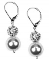 Grace through reflection: Crystal pave balls and glass pearls dangle from these gorgeous drop earrings set in imitation rhodium-plated mixed metal. Approximate drop: 1 inches.