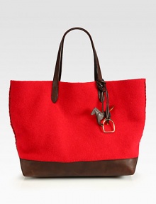 A classic style in warm wool felt accented in supple leather with cross stitch details.Double leather top handles, 9 dropOpen topOne inside open pocketOne detachable envelope pouch16½W X 14½H X 6½DMade in Italy A classic style in warm wool felt accented in supple leather with cross stitch details.Double leather top handles, 9 dropOpen topOne inside open pocketOne detachable envelope pouch16½W X 14½H X 6½DMade in Italy