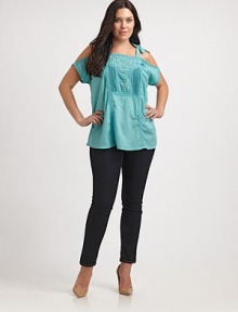 Show a little skin with this unique take on the classic peasant top. This cold-shoulder design features lovely eyelet and self-tie details. Square neckCold shouldersSelf-tiesEyelet and embroidered details at centerAbout 30 from shoulder to hemCottonMachine washImported