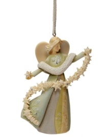 Let it snow. This lovely angel holds a shimmering strand of extraordinary snowflakes in this Angel with Snowflake ornament. Finished with sparkling crystal accents.