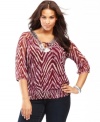 Get glowing with INC's plus size peasant top. Shimmering sequins at the neckline offset a bold print!