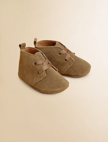 Adorable baby booties crafted in ultra-plush suede in a lace-up silhouette.Ribbon tieSuede upperLeather liningLeather solePadded insoleImported Adorable baby booties crafted in ultra-plush suede in a lace-up silhouette.Ribbon tieSuede upperLeather liningLeather solePadded insoleImported