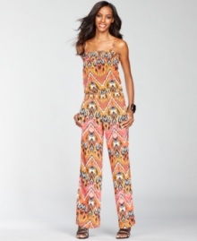 Whether you're wearing it as a cover-up or dressing it up with heels and sparkling jewelry, INC's exotic-print jumpsuit makes a surprisingly versatile addition to your wardrobe!