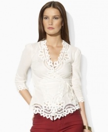 Steeped in vintage inspiration, Lauren Jeans Co.'s delicate wrap top is rendered in woven cotton and accented with lace detailing along the neckline, cuffs and hem.