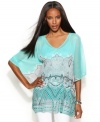 A unique print revs up INC's softly-draped peplum hem tunic. Try it with shorts to balance the flowing fit.