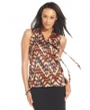 Get on trend with ABG's sleeveless blouse, featuring a bold graphic print and feminine tie-neck detail.