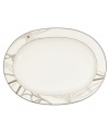 Abstract markings in soft shades of khaki frame this glazed white oval platter for unconventional elegance. Trimmed with matte platinum for modern polish on casual and formal tables alike. From Noritake's collection of serveware and serving dishes.