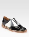 Step out in this easy lace-up design of patent leather, with metallic paneling for a touch of glam. Patent leather upperLeather liningRubber solePadded insoleImported