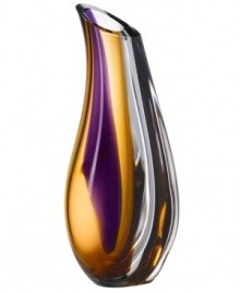 With the extraordinary beauty and grace of an orchid blossom, this Kosta Boda vase adds brilliant artistry to modern interiors. Luxurious art glass handcrafted in a wide, fluid shape glistens with streaks of rich violet and warm amber.