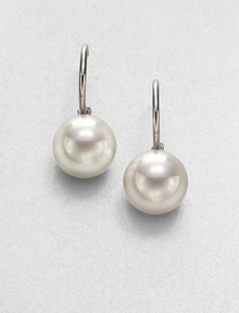 Lustrous white pearls on a sterling silver hoop design. 14mm organic round white man-made pearlSterling silverLength, about .75Post backImported Lustrous white pearls on a sterling silver hoop design. 14mm organic round white man-made pearlSterling silverLength, about .75Post backImported