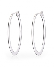 Polish your look in sleek, modern style. Monet earrings feature a sophisticated oval hoop set in silver tone mixed metal. Approximate diameter: 2 inches.