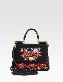 A cotton cross-stitch style in a floral design with leather trim and a convenient detachable strap.Leather top handle, 3 dropDetachable adjustable leather shoulder strap, 21½-25½ dropMagnetic snap flap closureOne inside open pocketSatin lining8W X 6¾H X 3½DMade in Italy A cotton cross-stitch style in a floral design with leather trim and a convenient detachable strap.Leather top handle, 3 dropDetachable adjustable leather shoulder strap, 21½-25½ dropMagnetic snap flap closureOne inside open pocketSatin lining8W X 6¾H X 3½DMade in Italy