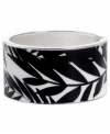 Infuse your look with the bold colors and exotic prints of Brasil. Crafted in silver tone mixed metal Haskell's Palm bangle features black and white palm leaf details and a hinge clasp. Approximate diameter: 2-1/2 inches. Approximate length: 8 inches. Item comes packaged in an orange gift box.