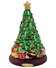 As festive as a real fir, the Lavish Tree figurine is elaborately hand painted in red, gold and glitter. Brilliant wrapped packages add to the cheerful scene from Christopher Radko.