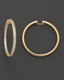 Inside out pavé-set diamond hoop earrings in yellow gold. Inside out pavé-set diamond hoop earrings in yellow gold.