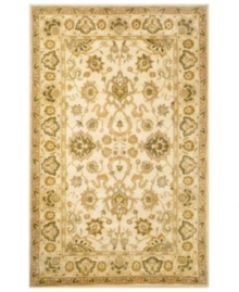 Drawing inspiration from the sandy ruins of ancient Petra and the traditional designs of India, this elegant, hand-tufted rug presents a rich decorative history set against a subtle ivory backdrop and accented with multiple gold and green tones.