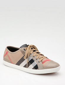 The traditional low-top gets the Burberry treatment in a classic canvas check with leather trim.Lace-up front with signature leather patch Leather toe cap Leather lining and sole Padded insole ImportedOUR FIT MODEL RECOMMENDS ordering true whole size; ½ sizes should order the next whole size down. 