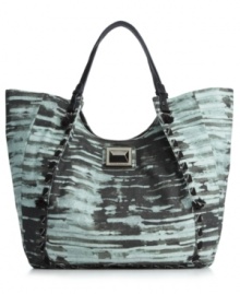 Keep things interesting with this ultra alluring canvas tote from Rachel Rachel Roy. Heavy stitching and oversized pyramid hardware make this this unique design truly one of a kind. Keep things interesting with this ultra alluring canvas tote from Rachel Rachel Roy. Heavy stitching and oversized pyramid hardware make this this unique design truly one of a kind.