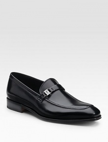 A slip-on dress standard crafted from polished leather with a silvertone side ornament. Leather lining Padded insole Rubber sole Made in Italy 