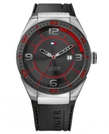 Bold color gives this casual watch from Tommy Hilfiger a modern air. Crafted of black silicone strap and round stainless steel case with logo. Black bezel features red numerals and stick markers. Black dial features silver tone numerals at three, six, nine and twelve o'clock, tachymeter scale, red inner minute track and stick markers, cut-out silver tone hour and minute hands, red second hand, date window at three o'clock and iconic flag logo at twelve o'clock. Quartz movement. Water resistant to 50 meters. Ten-year limited warranty.