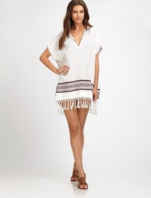 An exotic hooded coverup with exquisite embroidery, tassel details and gorgeous fringe. V-neckShort sleevesTassel detailsCottonDry cleanImported An exotic hooded coverup with exquisite embroidery, tassel details and gorgeous fringe. V-neckShort sleevesTassel detailsCottonDry cleanImported