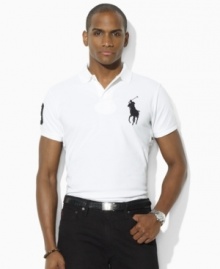 Designed with a trim cut through the body and a shorter hem, an iconic polo shirt is rendered in breathable cotton mesh with athletic details for sporty style. Designed with a trim cut through the body and a shorter hem, an iconic polo shirt is rendered in breathable cotton mesh with athletic details for sporty style.