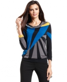Alfani's latest petite top combines a graphic print with flattering elements, like a cowl neckline and ruched cuffs. Alfani's latest petite top combines a graphic print with flattering elements, like a cowl neckline and ruched cuffs.