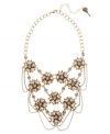 Blooming style, by Betsey Johnson. This statement necklace features multi-linked flower pendants encrusted with crystal accents. Crafted in antique gold-plated mixed metal with crystal cup chain details. Approximate length: 16 inches + 3-inch extender. Approximate drop: 4-1/2 inches.