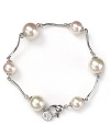 Luminous and versatile. Pearls are always a classic, and this curved link bracelet from Majorica is a delicate way to wear them.