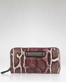 Sam Edelman's sleek snake print wallet keeps your essentials safely stowed with a secure zip around closure. Sam Edelman's sleek snake print wallet keeps your essentials safely stowed with a secure zip around closure.