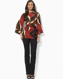 A bold geometric pattern enlivens a modern dolman-sleeved tunic, crafted in fluid silk for a luxurious feel. A bold geometric pattern enlivens a modern dolman-sleeved tunic, crafted in fluid silk for a luxurious feel.